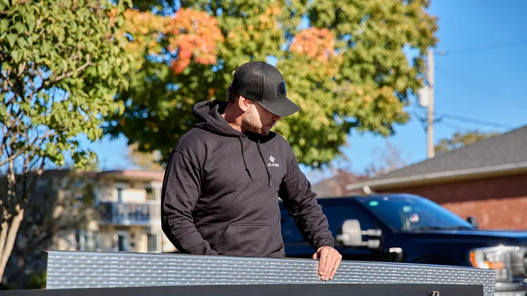 Two installers working on a seamless gutter run in the Piedmont